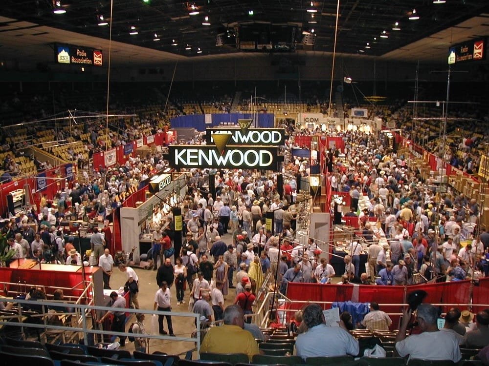 Participants crowded on the show floor at Dayton Hamvention, exploring vendors selling equipment and showcasing top ham radio destinations.