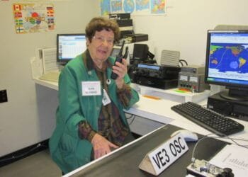 Jean Moffett, VE3WAD, operating a Digital Mobile Radio (DMR) setup at the Ontario Science Centre amateur radio station, demonstrating the technology to visitors.
