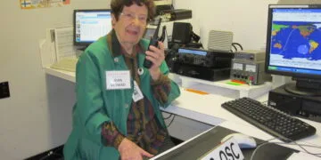 Jean Moffett, VE3WAD, operating a Digital Mobile Radio (DMR) setup at the Ontario Science Centre amateur radio station, demonstrating the technology to visitors.