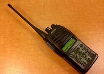 A Connect Systems CS700 handheld DMR radio showing its front display, keypad, and PTT button on the side.