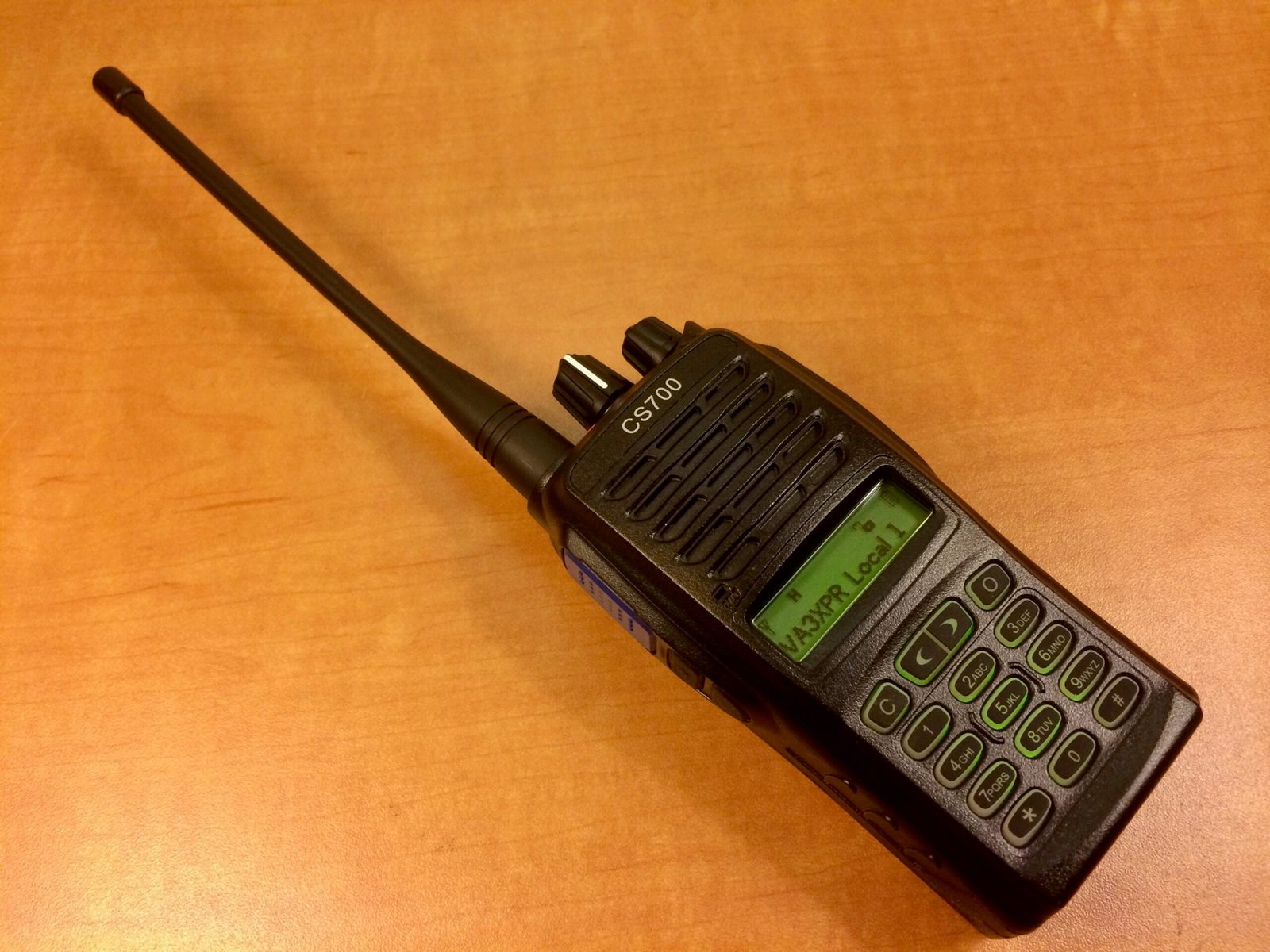 A Connect Systems CS700 handheld DMR radio showing its front display, keypad, and PTT button on the side.