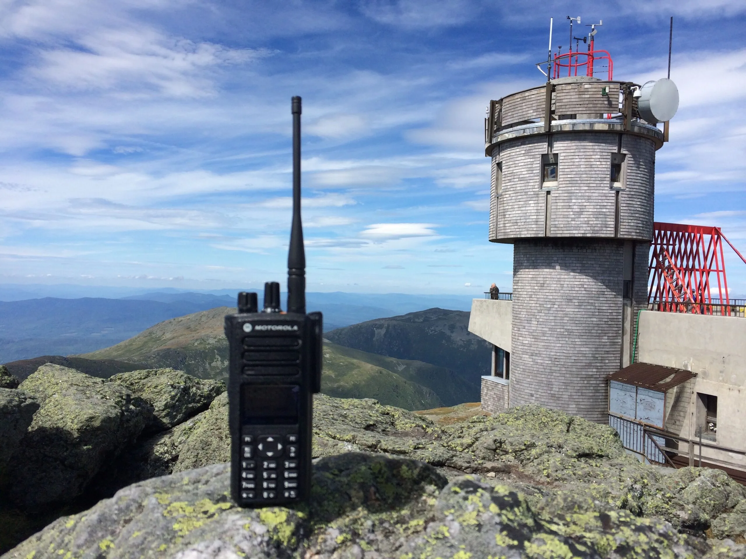 The Motorola XPR 7550 radio sitting on a rock at the summit of Mount Washington, New Hampshire.