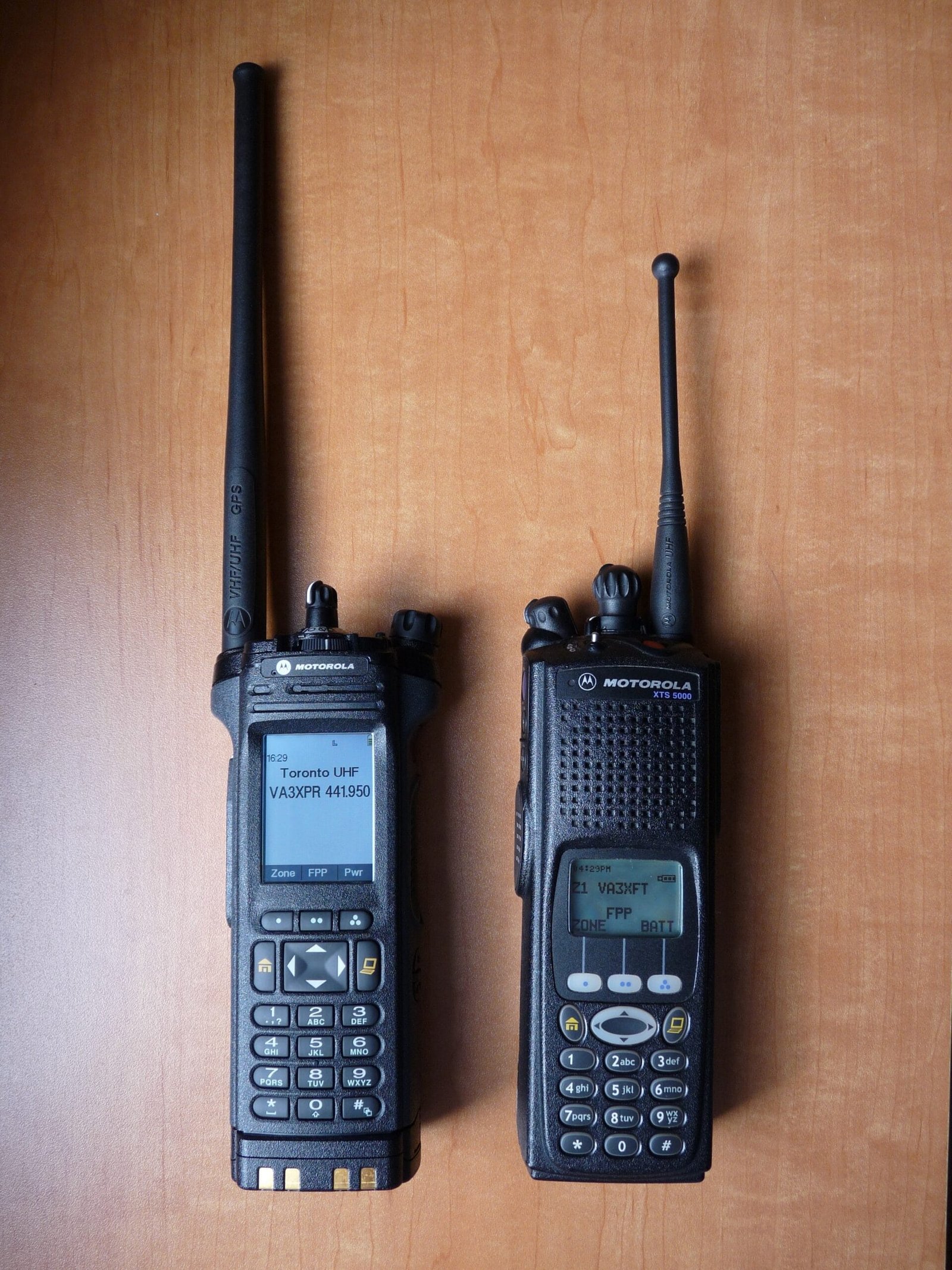 Front view of Motorola APX 7000 next to Motorola XTS 5000 handheld radios.