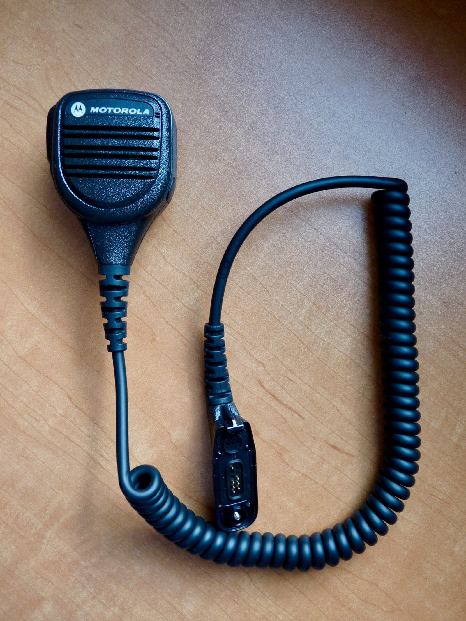 Motorola APX 7000 speaker microphone for hands-free two-way radio use.