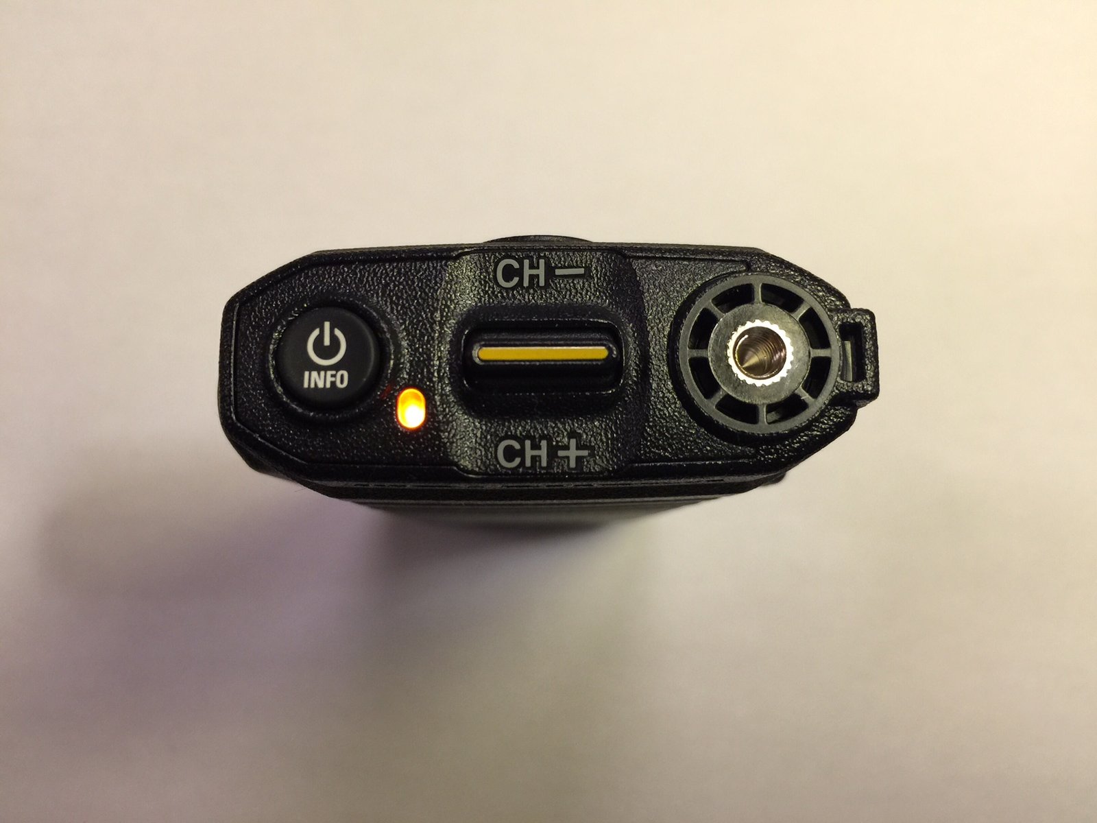 Top view of the Motorola SL300 DMR radio highlighting the power button, LED status indicator, channel toggle switch, and antenna connector.