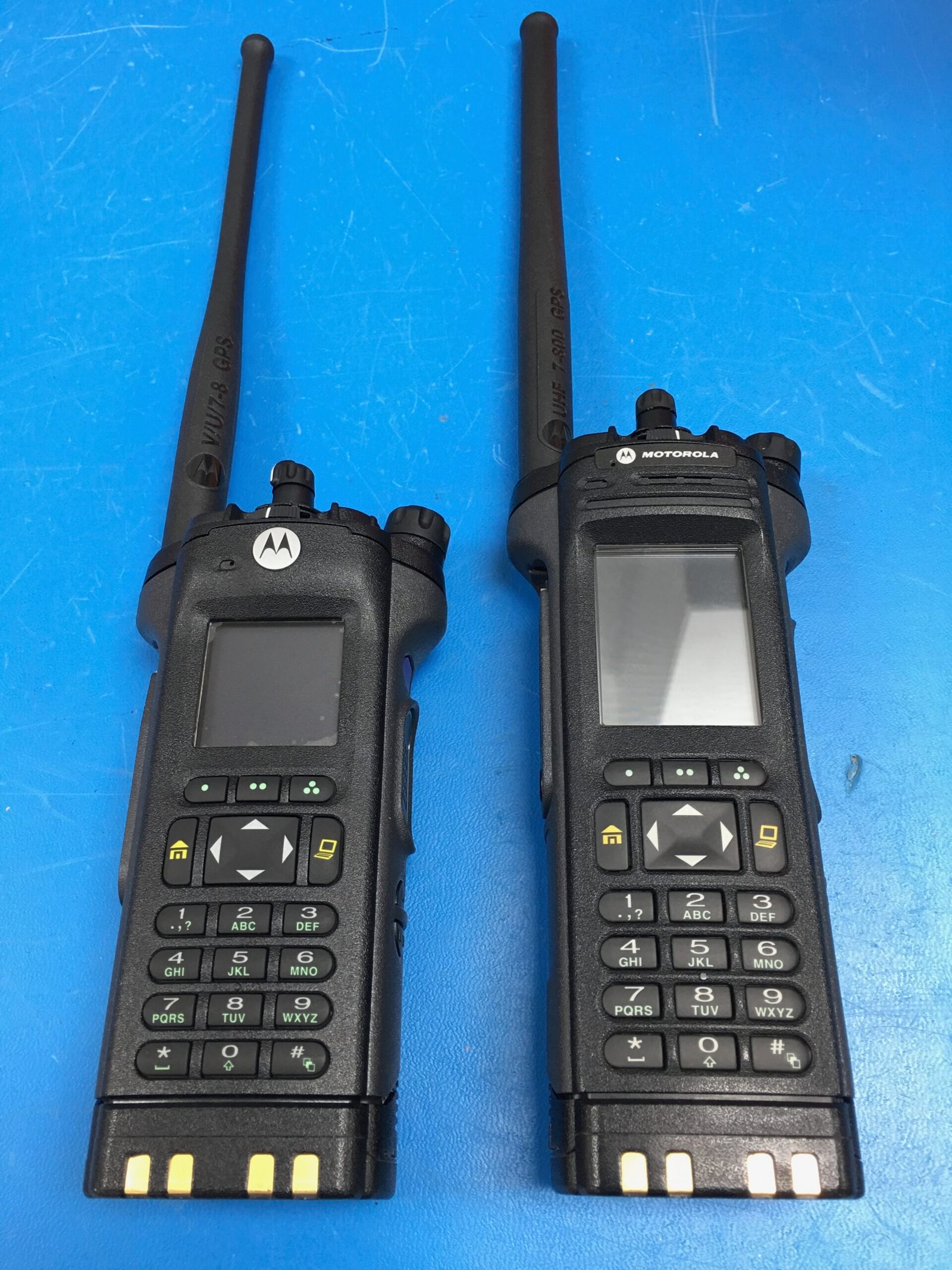 Two Motorola P25 handheld radios, APX 8000 on the left and APX 7000 on the right, used by hams for digital voice in ham radio.