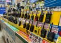DMR vs Fusion vs D-Star handheld radios on display in an Akihabara ham radio store in Tokyo—rows of analog and digital portable transceivers with price tags.