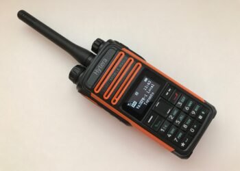 Hytera TD580 review - rugged orange-and-black DMR handheld radio with display and keypad.