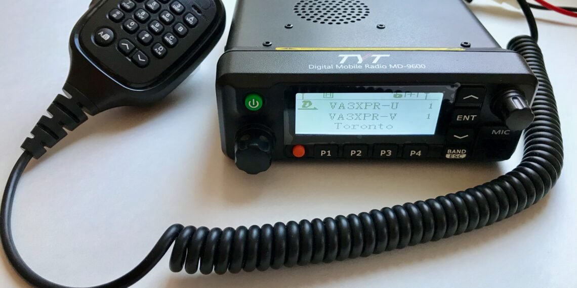 TYT MD-9600 dual-band DMR mobile radio with microphone and display powered on.