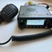 TYT MD-9600 dual-band DMR mobile radio with microphone and display powered on.