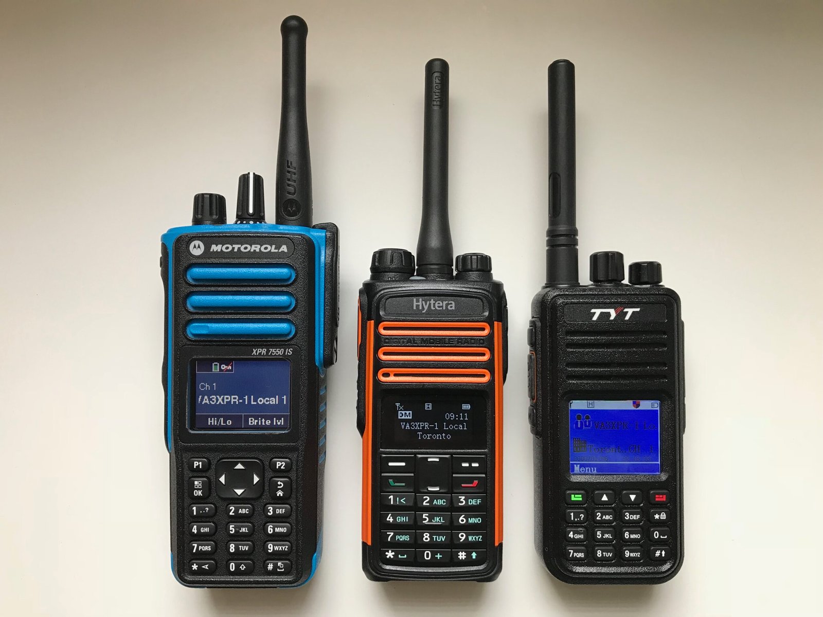 Hytera TD580 beside Motorola XPR7550IS and TYT MD-380 showing DMR radio size and design comparison.