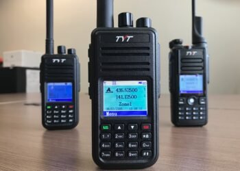 TYT MD-UV380 dual-band DMR handheld radio front view with MD-380 and MD-2017 models in background.
