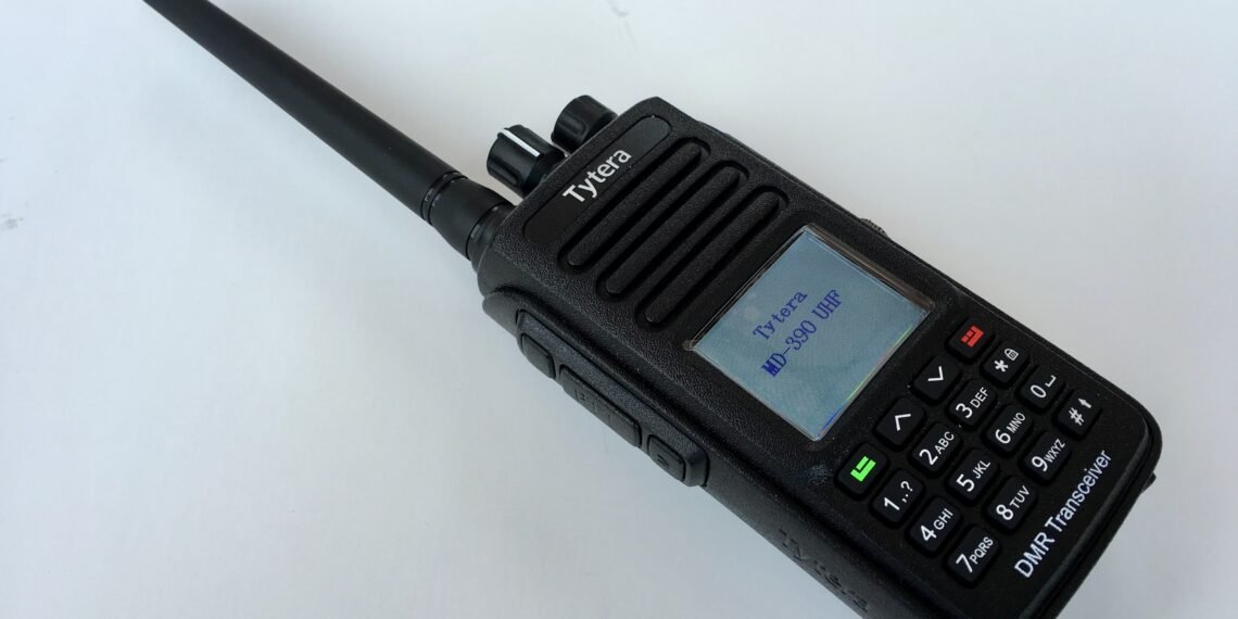 TYT MD-390 waterproof DMR handheld radio with whip antenna and illuminated colour LCD screen.