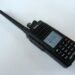 TYT MD-390 waterproof DMR handheld radio with whip antenna and illuminated colour LCD screen.