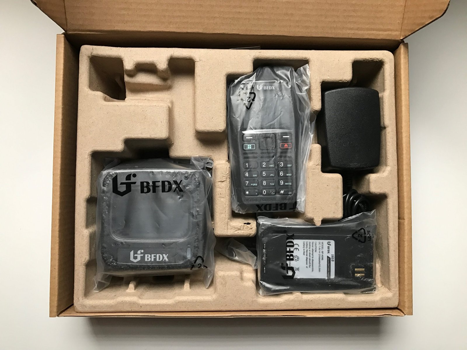 Connect Systems CS580 DMR handheld radio with battery, charger, and accessories inside the box.