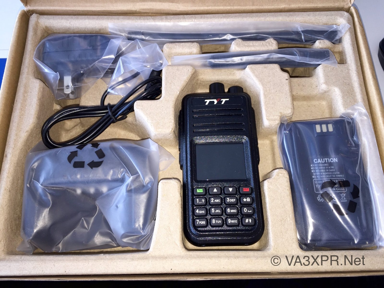 TYT MD-380 UHF DMR handheld radio package showing included accessories such as antennas, charger, and battery.