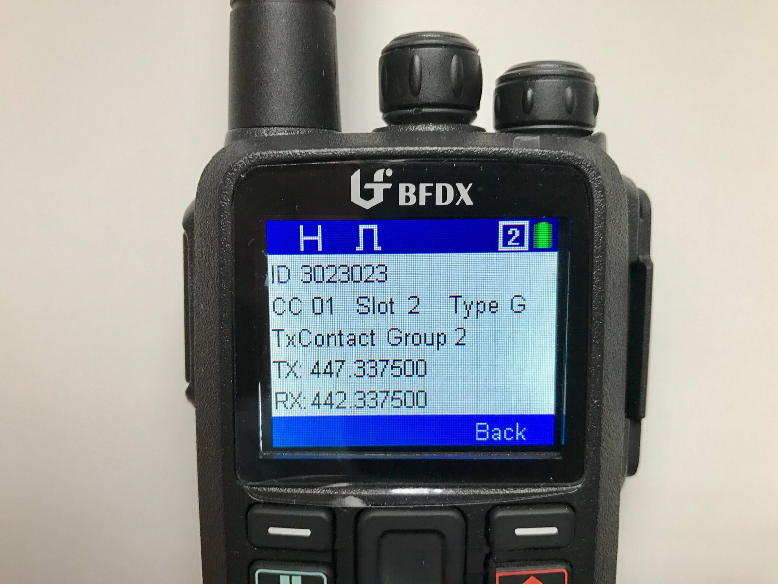 Connect Systems CS580 DMR handheld radio display showing talkgroup and frequency information.