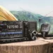 D-STAR for Beginners – Icom IC-705 portable D-STAR radio set up outdoors on a wooden table beside a tent, ready for QRP digital voice operation. Photo credit Icom Inc.