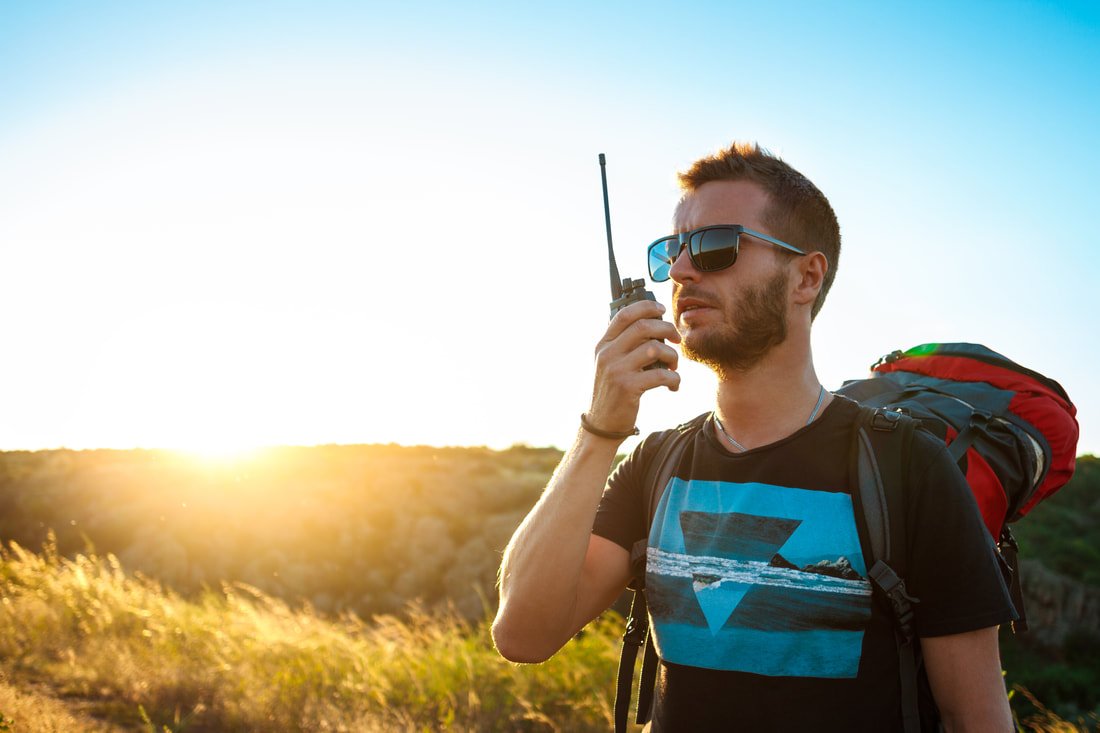 D-STAR for Beginners – new ham radio operator outdoors making a first digital voice contact using D-STAR handheld radio.