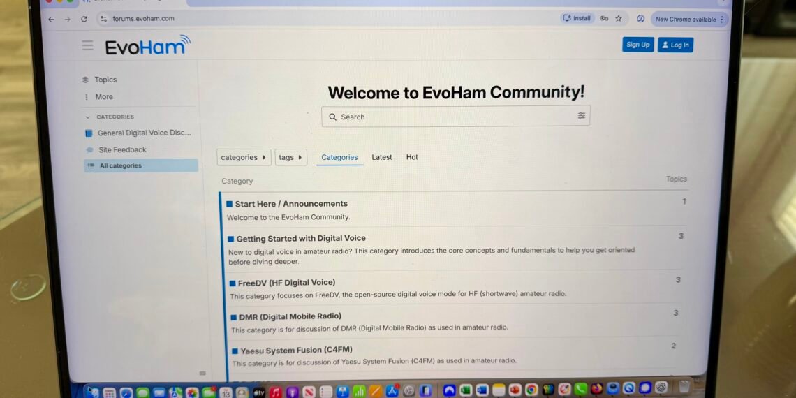 A laptop showing the EvoHam Community ham radio digital voice forum with categories for FreeDV, DMR and Yaesu System Fusion.